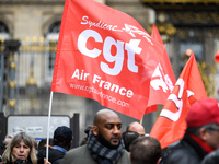 Striking Air France employees hold flags of French union CGT on March 12, 2018 in Paris, during a demonstration in front of the Palace of Ju...