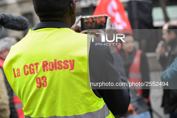 Striking Air France employees hold flags of French union CGT on March 12, 2018 in Paris, during a demonstration in front of the Palace of Ju...