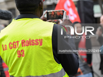 Striking Air France employees hold flags of French union CGT on March 12, 2018 in Paris, during a demonstration in front of the Palace of Ju...