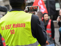 Striking Air France employees hold flags of French union CGT on March 12, 2018 in Paris, during a demonstration in front of the Palace of Ju...