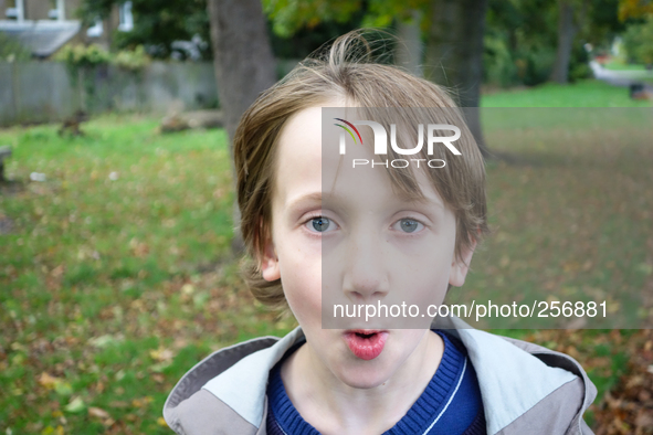 London, Robin at seven years old in his favorite park impressed watching the camera 