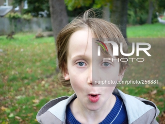 London, Robin at seven years old in his favorite park impressed watching the camera (