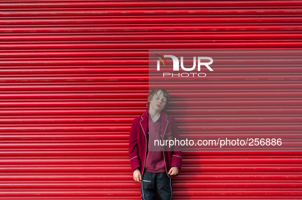 London, Robin at eight years old, after school have a break during the long walk to reach home. 