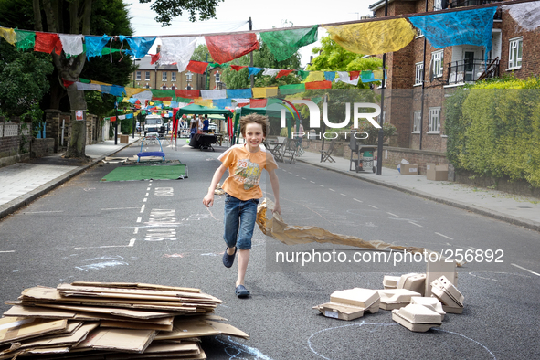 London, Robin eight years old, running during a street party near his house. 