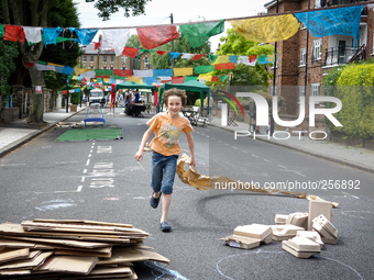 London, Robin eight years old, running during a street party near his house. (