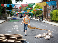 London, Robin eight years old, running during a street party near his house. (