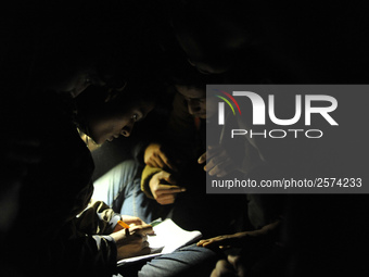 Nepalese Youths using mobile phones as lining in the night to pay the amount for the application submission for the Korean Language Test (KL...