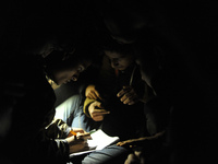 Nepalese Youths using mobile phones as lining in the night to pay the amount for the application submission for the Korean Language Test (KL...