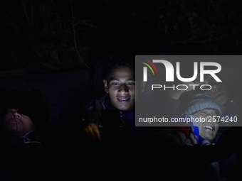 Nepalese Youths using mobile phones as lining in the night to pay the amount for the application submission for the Korean Language Test (KL...