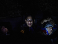 Nepalese Youths using mobile phones as lining in the night to pay the amount for the application submission for the Korean Language Test (KL...