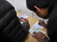 Nepalese Youths filling the pay slip of the amount for the application submission for the Korean Language Test (KLT) under the Korea Employm...