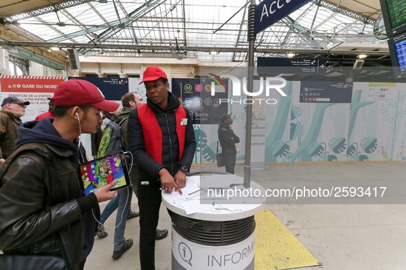 SNCF (French National Railway Corporation) employee speak with travellers to inform them on a platform of the Gare de l’Est railway station...