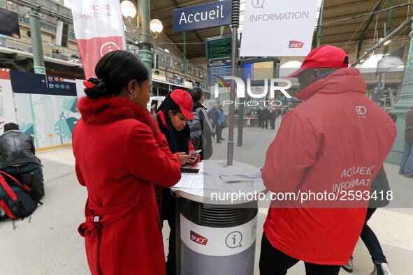 SNCF (French National Railway Corporation) employee speak with travellers to inform them on a platform of the Gare de l’Est railway station...