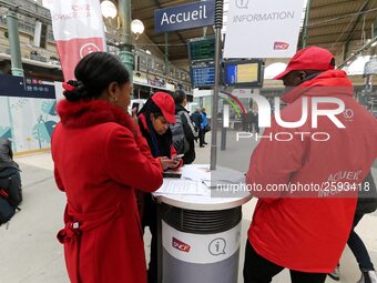 SNCF (French National Railway Corporation) employee speak with travellers to inform them on a platform of the Gare de l’Est railway station...