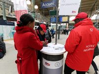 SNCF (French National Railway Corporation) employee speak with travellers to inform them on a platform of the Gare de l’Est railway station...