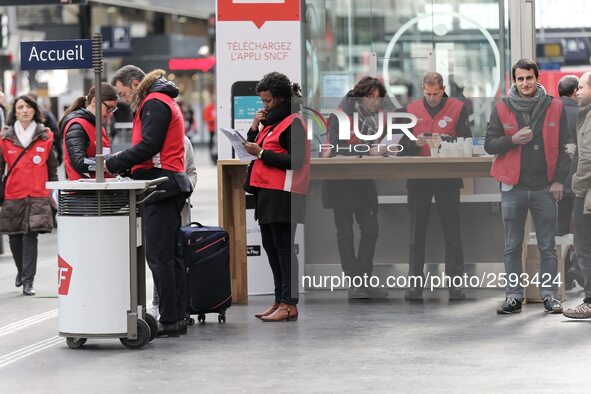 SNCF (French National Railway Corporation) employees speak with travellers to inform them on a platform of the Gare de l’Est railway station...