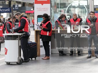 SNCF (French National Railway Corporation) employees speak with travellers to inform them on a platform of the Gare de l’Est railway station...