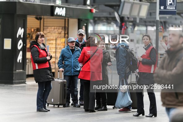 SNCF (French National Railway Corporation) employees speak with travellers to inform them on a platform of the Gare de l’Est railway station...