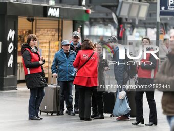 SNCF (French National Railway Corporation) employees speak with travellers to inform them on a platform of the Gare de l’Est railway station...