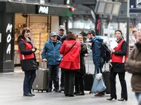 SNCF (French National Railway Corporation) employees speak with travellers to inform them on a platform of the Gare de l’Est railway station...