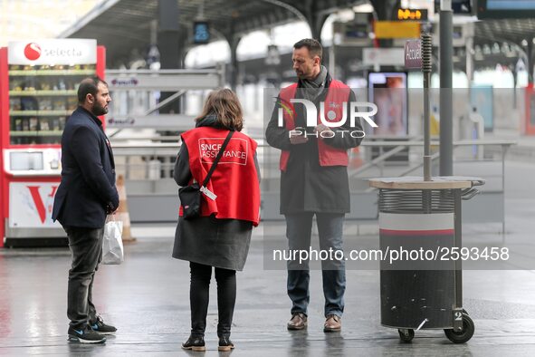 SNCF (French National Railway Corporation) employees speak with travellers to inform them on a platform of the Gare de l’Est railway station...