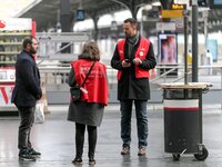 SNCF (French National Railway Corporation) employees speak with travellers to inform them on a platform of the Gare de l’Est railway station...