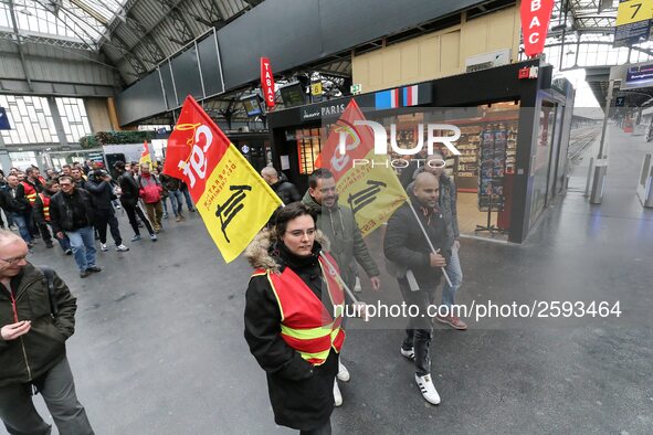 Protestors hold CGT union flags during a demonstration inside the Gare de L'Est train station on April 3, 2018 in Paris, on the first day of...