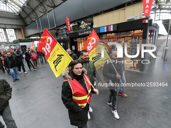 Protestors hold CGT union flags during a demonstration inside the Gare de L'Est train station on April 3, 2018 in Paris, on the first day of...