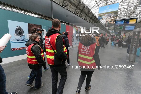 Protestors wearing CGT union jackets walk inside the Gare de L'Est train station on April 3, 2018 in Paris, on the first day of a two day st...