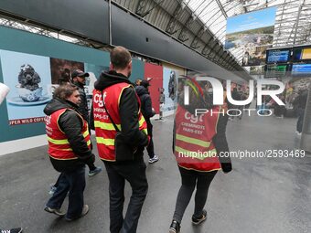 Protestors wearing CGT union jackets walk inside the Gare de L'Est train station on April 3, 2018 in Paris, on the first day of a two day st...