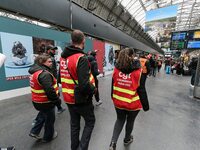 Protestors wearing CGT union jackets walk inside the Gare de L'Est train station on April 3, 2018 in Paris, on the first day of a two day st...