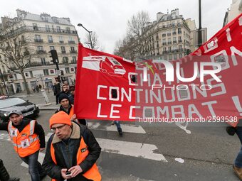 Employees of the French state owned railway company SNCF wearing union jackets and holding a banner demonstrate in front of the Gare de L'Es...