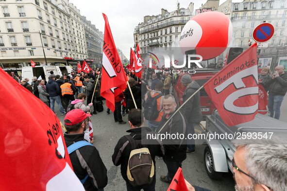 Employees of the French state owned railway company SNCF wearing union jackets and holding a banner demonstrate in front of the Gare de L'Es...