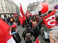 Employees of the French state owned railway company SNCF wearing union jackets and holding a banner demonstrate in front of the Gare de L'Es...