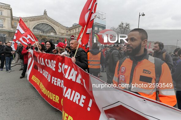 Employees of the French state owned railway company SNCF wearing union jackets and holding a banner demonstrate in front of the Gare de L'Es...