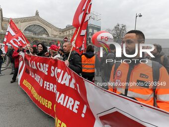 Employees of the French state owned railway company SNCF wearing union jackets and holding a banner demonstrate in front of the Gare de L'Es...