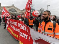 Employees of the French state owned railway company SNCF wearing union jackets and holding a banner demonstrate in front of the Gare de L'Es...