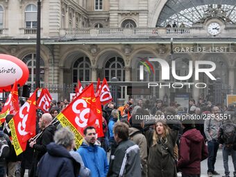 Employee of the French state owned railway company SNCF holding flags demonstrate in front of the Gare de L'Est train station on April 3, 20...