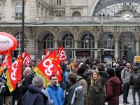 Employee of the French state owned railway company SNCF holding flags demonstrate in front of the Gare de L'Est train station on April 3, 20...