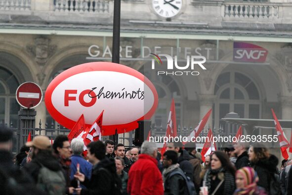 Employee of the French state owned railway company SNCF holding flags demonstrate in front of the Gare de L'Est train station on April 3, 20...