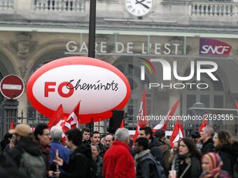 Employee of the French state owned railway company SNCF holding flags demonstrate in front of the Gare de L'Est train station on April 3, 20...