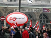 Employee of the French state owned railway company SNCF holding flags demonstrate in front of the Gare de L'Est train station on April 3, 20...