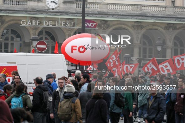 Employee of the French state owned railway company SNCF holding flags demonstrate in front of the Gare de L'Est train station on April 3, 20...