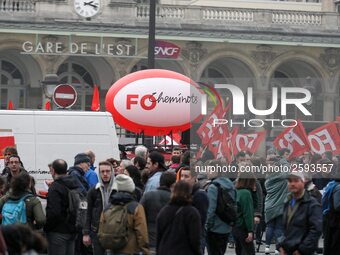 Employee of the French state owned railway company SNCF holding flags demonstrate in front of the Gare de L'Est train station on April 3, 20...