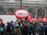 Employee of the French state owned railway company SNCF holding flags demonstrate in front of the Gare de L'Est train station on April 3, 20...