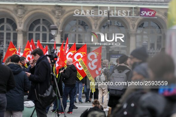 Employee of the French state owned railway company SNCF holding flags demonstrate in front of the Gare de L'Est train station on April 3, 20...