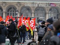 Employee of the French state owned railway company SNCF holding flags demonstrate in front of the Gare de L'Est train station on April 3, 20...