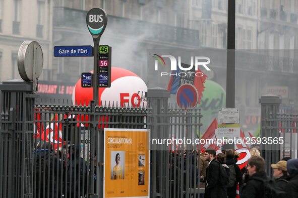 Employee of the French state owned railway company SNCF holding flags demonstrate in front of the Gare de L'Est train station on April 3, 20...