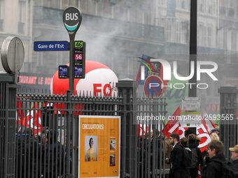 Employee of the French state owned railway company SNCF holding flags demonstrate in front of the Gare de L'Est train station on April 3, 20...