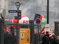 Employee of the French state owned railway company SNCF holding flags demonstrate in front of the Gare de L'Est train station on April 3, 20...